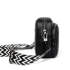 Durable black leather crossbody bag with multiple zippers, stylish black and white patterned strap, perfect for medical professionals or accessories lovers.