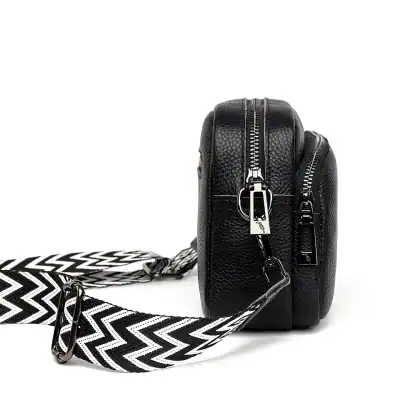Durable black leather crossbody bag with multiple zippers, stylish black and white patterned strap, perfect for medical professionals or accessories lovers.