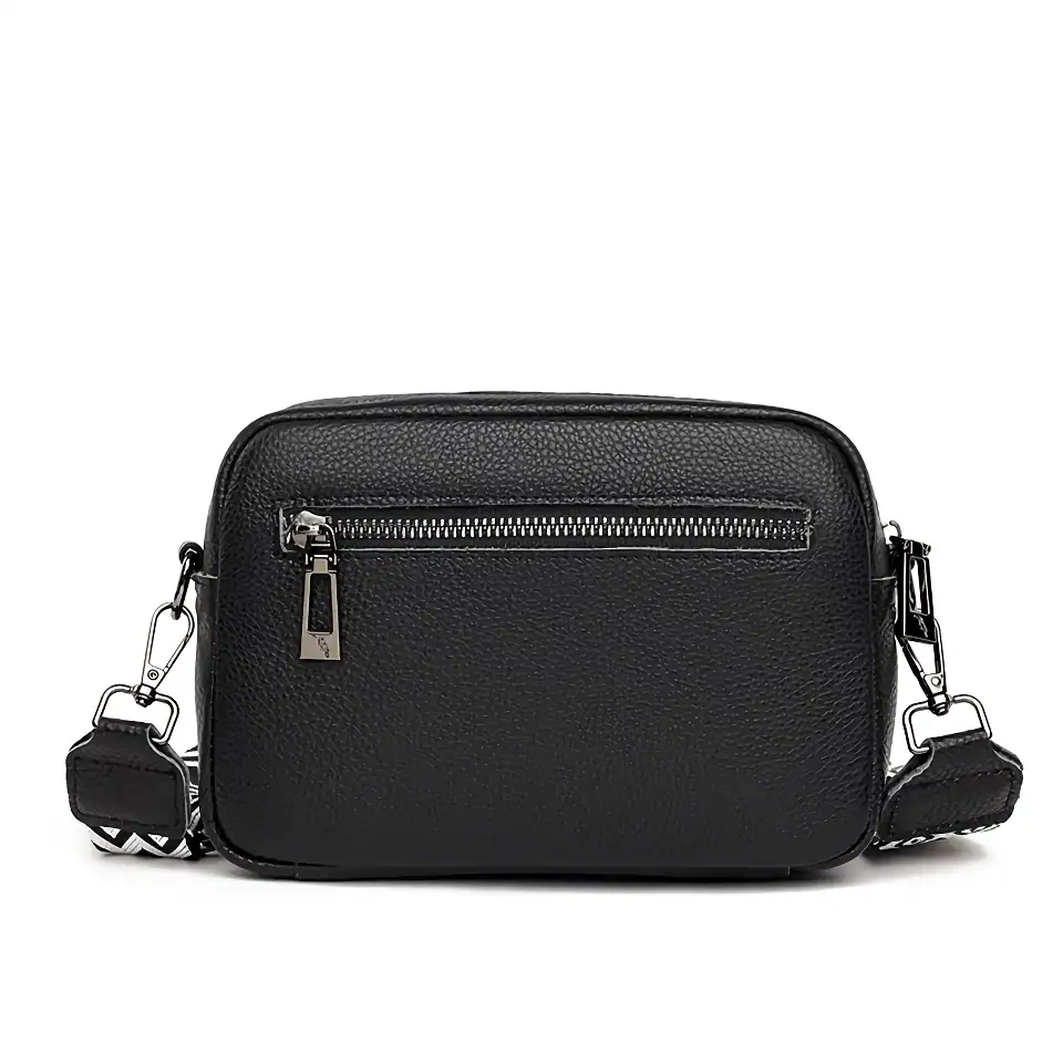 Stylish black leather crossbody bag with front zipper pocket, adjustable strap, perfect for everyday use or accessories. Durable, lightweight, and versatile for fashion-forward individuals.