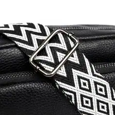 Zippered black leather handbag with a black and white geometric patterned strap, featuring a sleek metallic buckle, high-quality textured leather, perfect for fashionable everyday use.