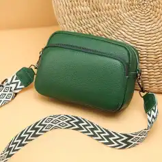 Versatile green leather crossbody bag with adjustable strap, perfect for daily use and travel. Stylish and functional accessory for women, ideal for carrying essentials.