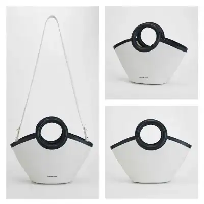 Stylish Monalisa handbag featuring a modern circular design in black and white, perfect for fashion-forward women seeking a chic and functional accessory.