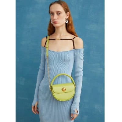 Stylish lime green crossbody purse featuring a sleek gold clasp, perfect for fashion-forward accessories. Ideal for casual or elegant outfits, offering a modern twist on essential jewelry and handbag trends.