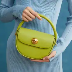 A stylish lime green handbag with gold accents, perfect for fashion-forward accessories and daily use.