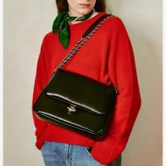 Elegant black leather crossbody purse with chain strap, perfect for casual or formal occasions, offering stylish functionality and top-tier quality.