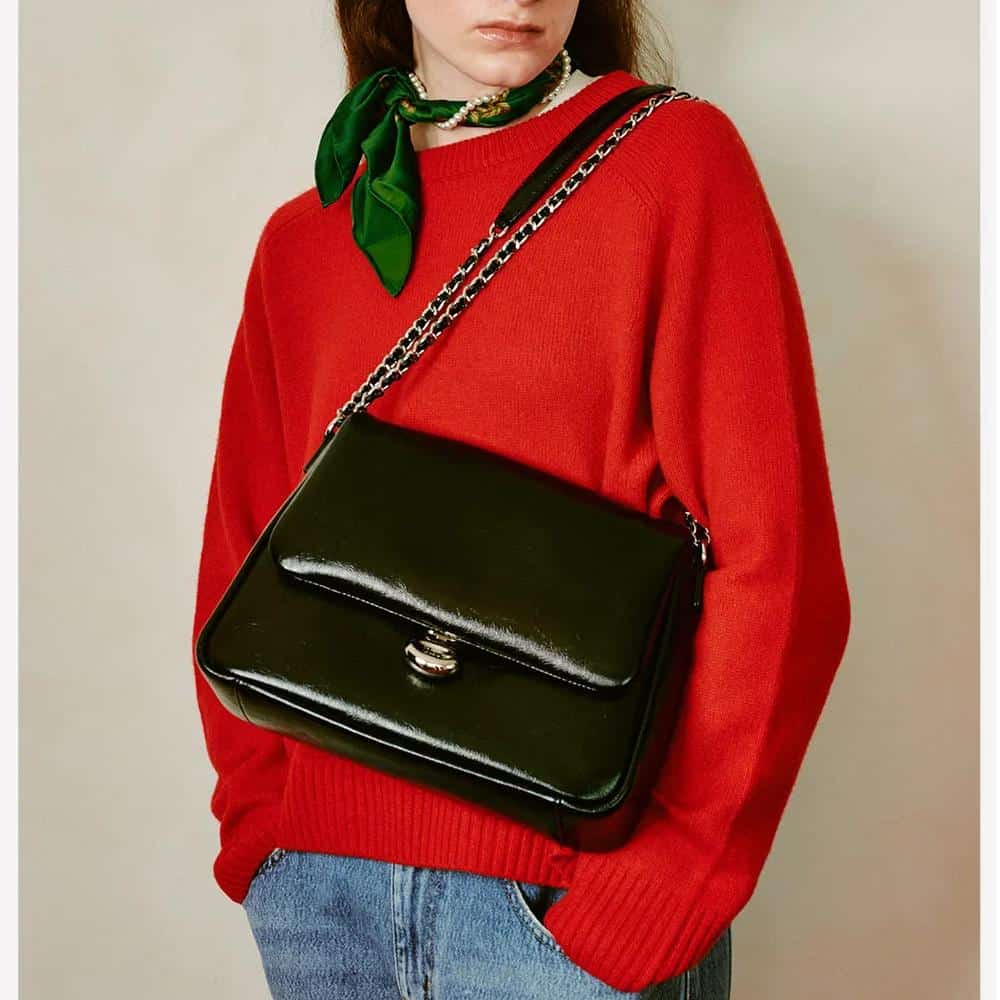 Elegant black leather crossbody purse with chain strap, perfect for casual or formal occasions, offering stylish functionality and top-tier quality.