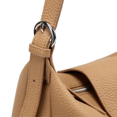 Stylish beige leather women's crossbody bag with silver hardware, adjustable strap, and secure zipper closure for versatile everyday use.