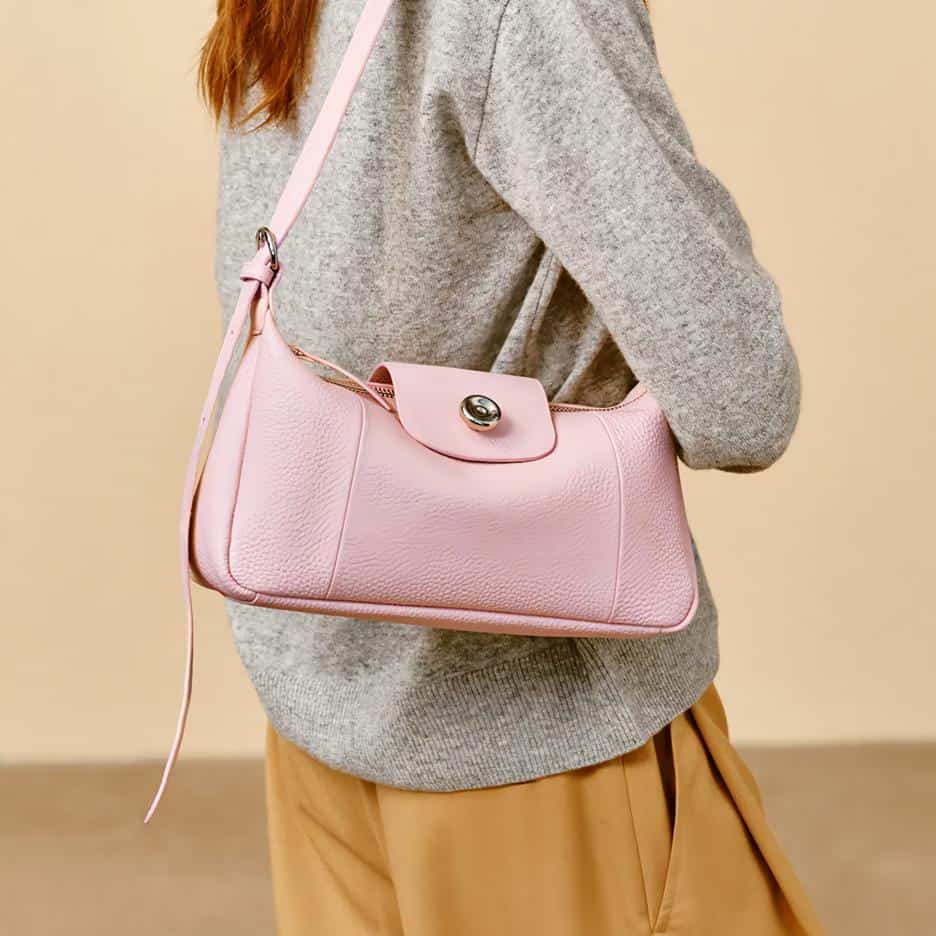 Stylish pink leather handbag with gold hardware, perfect for daily use and elegant outings, available at Monalisa Store.