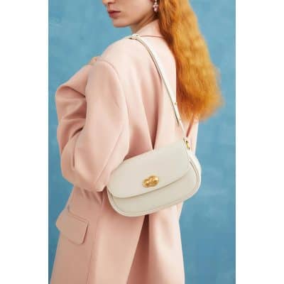 Elegant white women's handbag with gold clasp and adjustable strap, perfect for stylish accessories and casual or formal outfits.