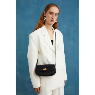 Elegant black handbag with gold accents for women.