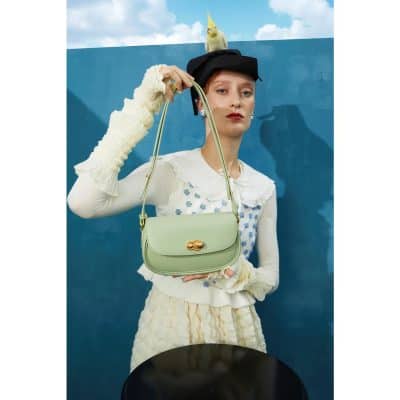 Stylish green shoulder bag with gold hardware, perfect for fashion-forward women seeking a versatile accessory.