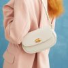 Elegant cream-colored shoulder bag with gold accents, perfect for stylish day outings or casual events. Crafted with premium materials for durability and timeless fashion appeal.