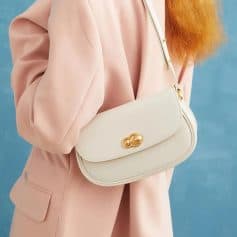 Elegant cream-colored shoulder bag with gold accents, perfect for stylish day outings or casual events. Crafted with premium materials for durability and timeless fashion appeal.