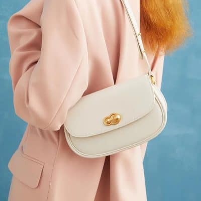Elegant cream-colored shoulder bag with gold accents, perfect for stylish day outings or casual events. Crafted with premium materials for durability and timeless fashion appeal.