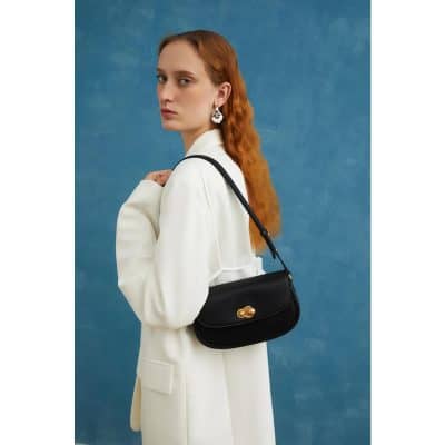 High-quality black shoulder bag with gold clasp, perfect for fashion-forward women. Stylish and versatile accessory available at Monalisa Store for modern, trendy looks.
