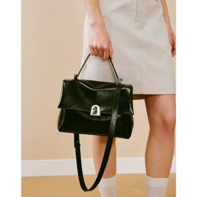 Elegant black leather handbag with silver clasp, perfect for stylish occasions. Features a top handle and adjustable strap for versatile wear, emphasizing fashion and functionality.