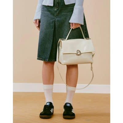 High-quality beige leather tote bag with adjustable strap, elegant design, perfect for daily use or special occasions.