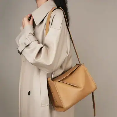 Stylish tan leather handbag with adjustable strap for women, perfect for fashion-forward accessory. Ideal for daily use, travel, or special occasions.