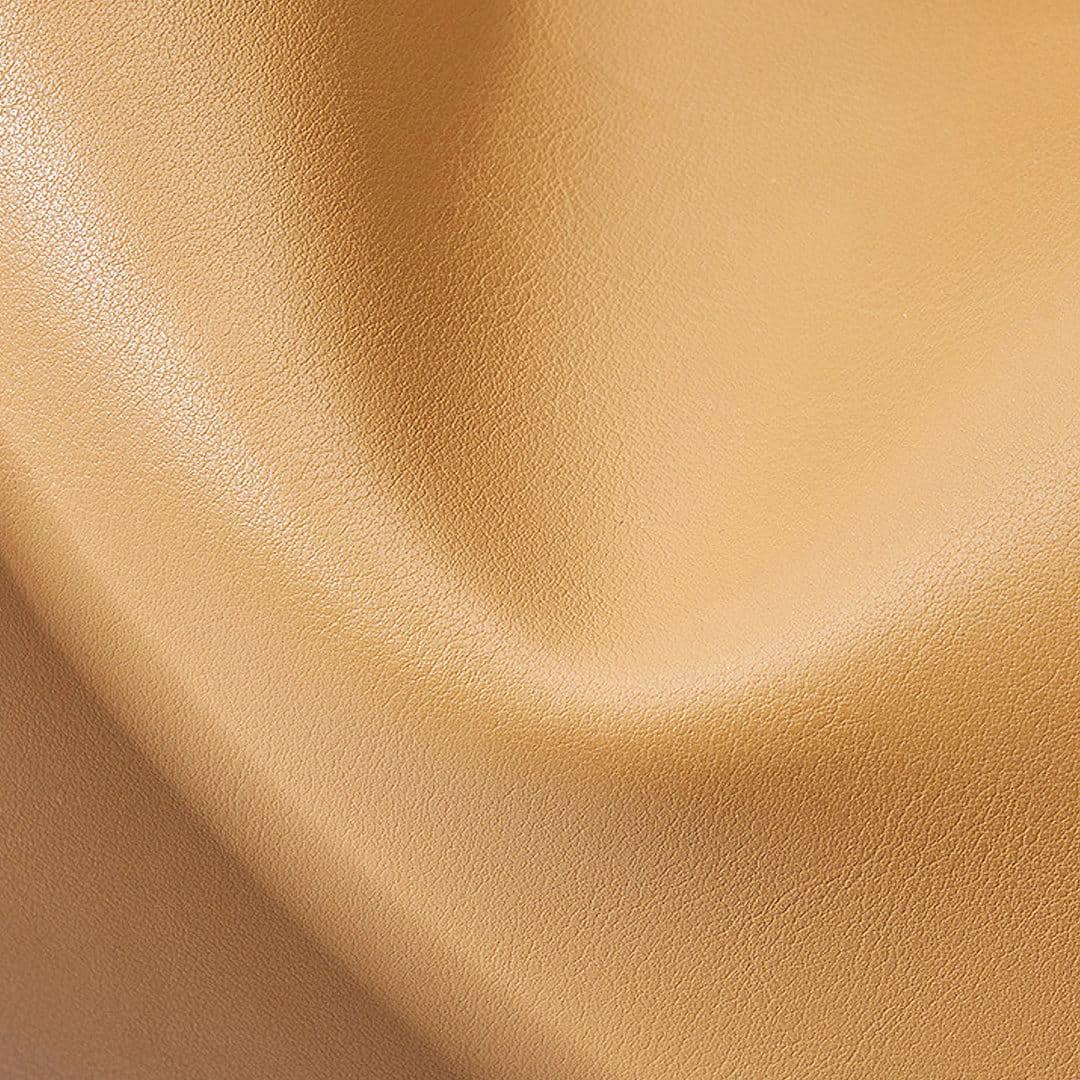 Close-up of premium golden optic fabric, ideal for sunglasses and eyewear accessories, showcasing superior quality, sleek finish, and elegant appeal for optical stores.