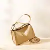 Beige handbag with zipper closure, adjustable strap, and stylish design, ideal for daily use, fashion accessories, and versatile styling. Perfect for women seeking elegant, functional carry options.