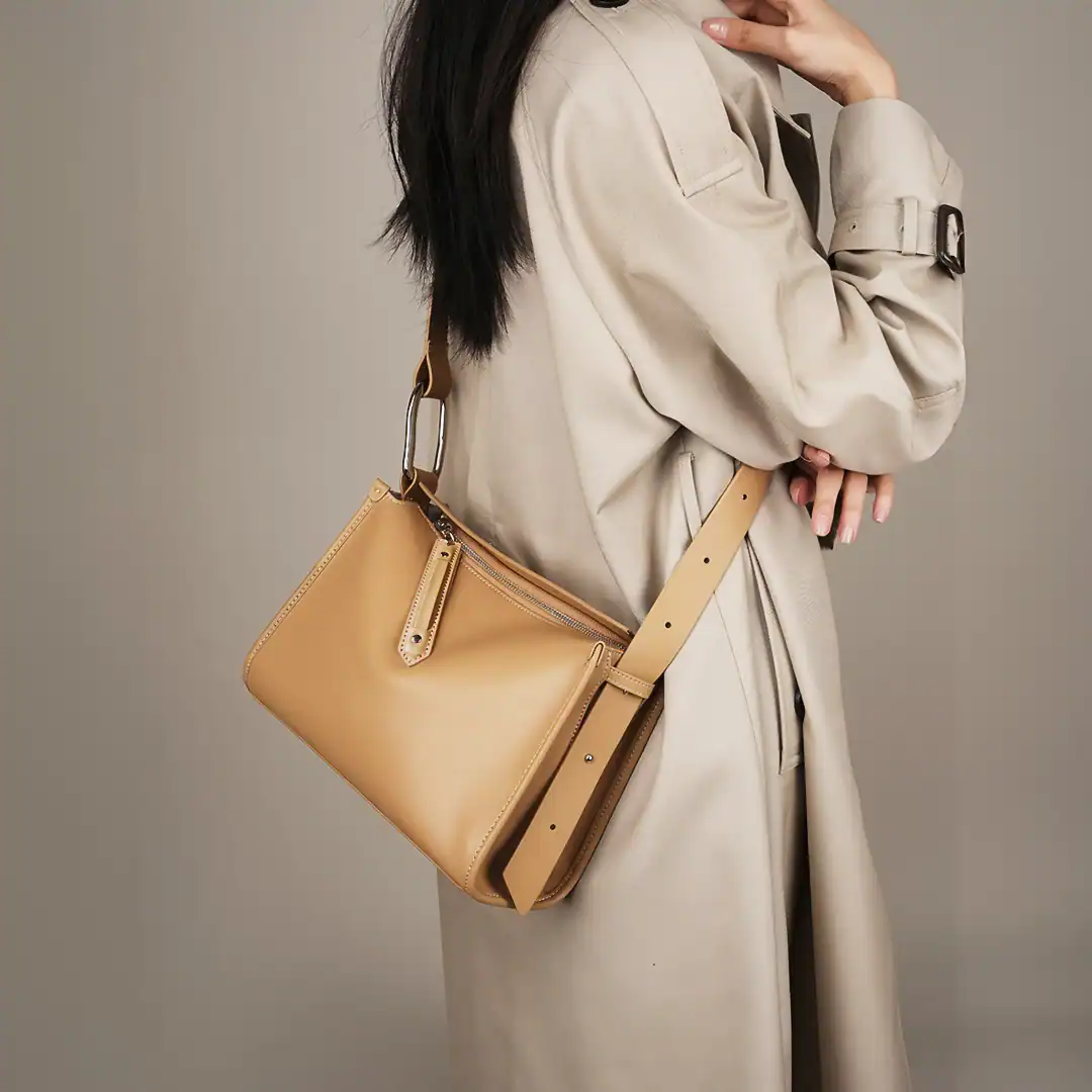 Elegant beige crossbody bag with adjustable strap, zipper compartment, ideal for stylish and practical accessories.