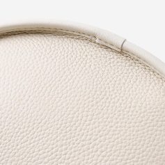 Elegant white leather chair close-up image.