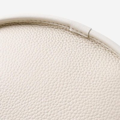 Elegant white leather chair close-up image.