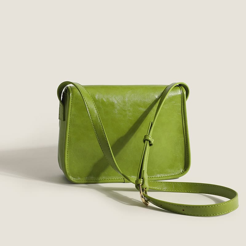 Stylish green leather handbag with adjustable strap, perfect for everyday wear and fashion-forward look. Made with sustainable materials, ideal for eco-conscious fashion lovers.