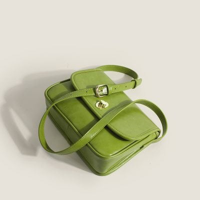 Elegant green designer handbag with adjustable strap and gold hardware, perfect for fashion-forward accessories.