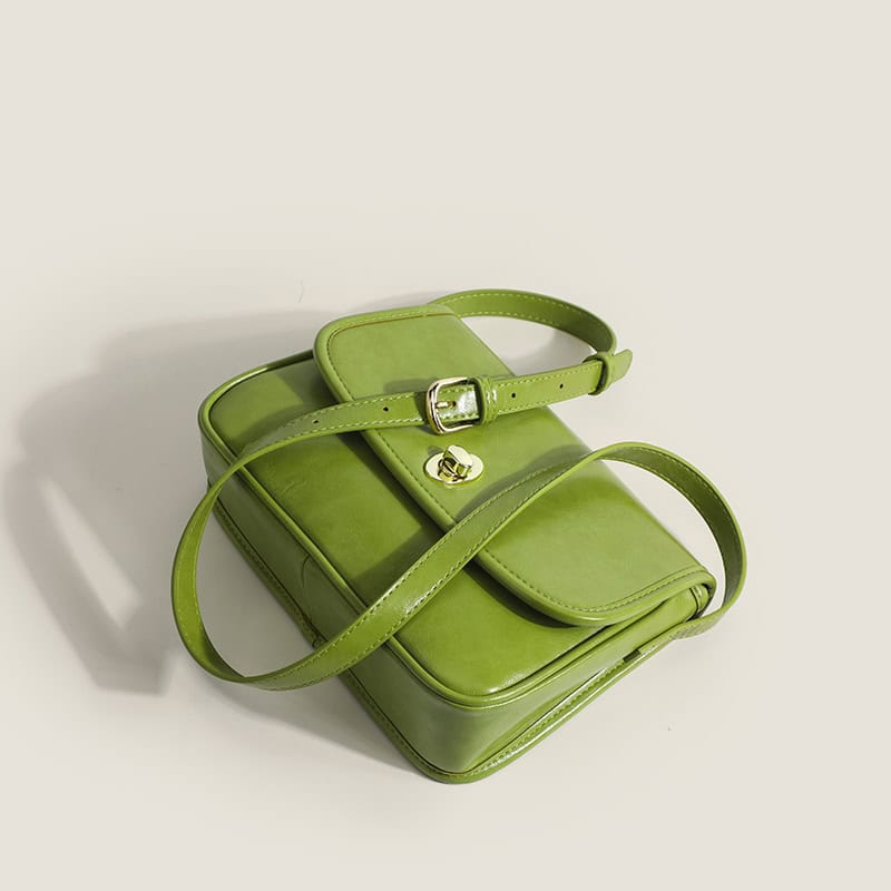 Elegant green designer handbag with adjustable strap and gold hardware, perfect for fashion-forward accessories.