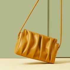 Stylish mustard yellow leather handbag with pleats, perfect for trendy accessories and daily use. Elegant and versatile design suitable for all seasons.