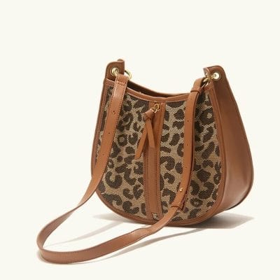 Leopard print designer handbag with leather accents, perfect for stylish women. Eye-catching accessory for everyday or special occasions.