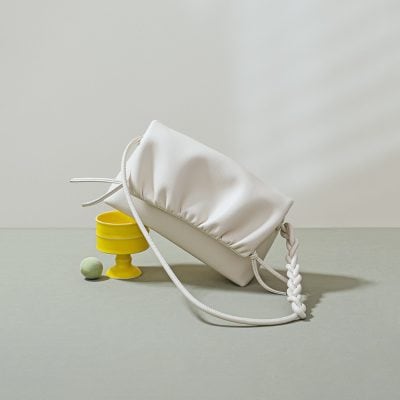 Optical accessories store featuring fashionable white optical bags for stylish eye care. Perfect for carrying glasses while complementing your look.