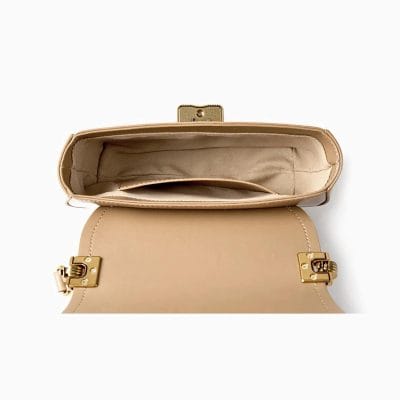 Elegant beige handbag with gold hardware, spacious interior, and stylish design perfect for fashion and accessory enthusiasts.