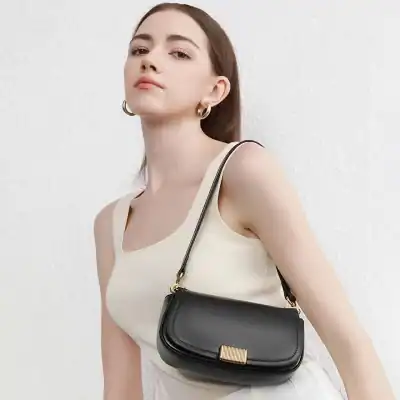 Stylish black crossbody bag for women with gold clasp, perfect for everyday use and fashion accessories. Compact, elegant, and versatile, ideal for casual outings or formal events.