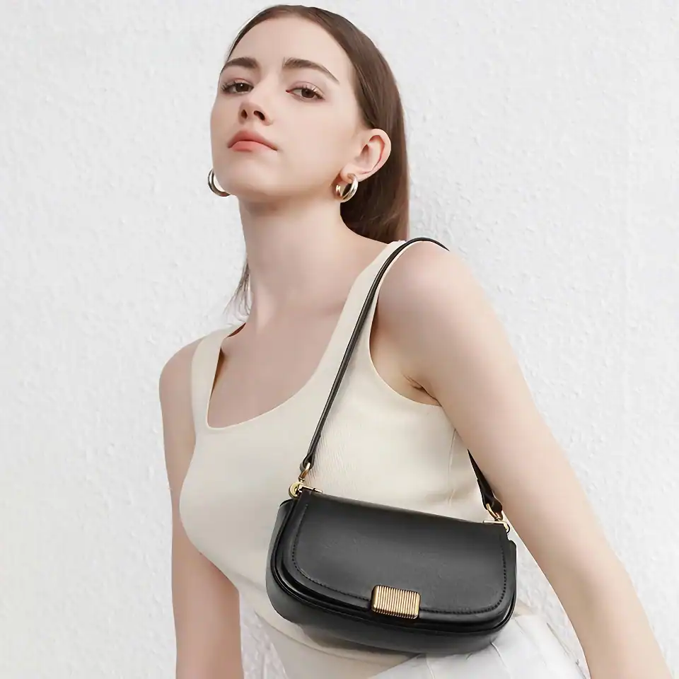 Stylish black crossbody bag for women with gold clasp, perfect for everyday use and fashion accessories. Compact, elegant, and versatile, ideal for casual outings or formal events.