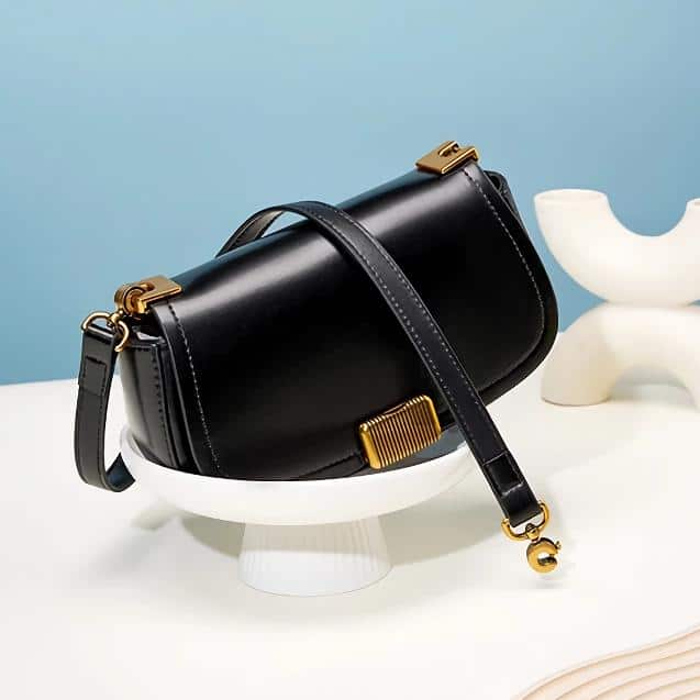 Luxury black leather handbag with gold accents, ideal for fashionable women seeking sophisticated accessories. Perfect for daily use or special occasions.