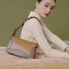 Elegant designer handbag with a woven leather handle, perfect for stylish women. Crafted for sophistication and functionality, ideal for daily use and special occasions.