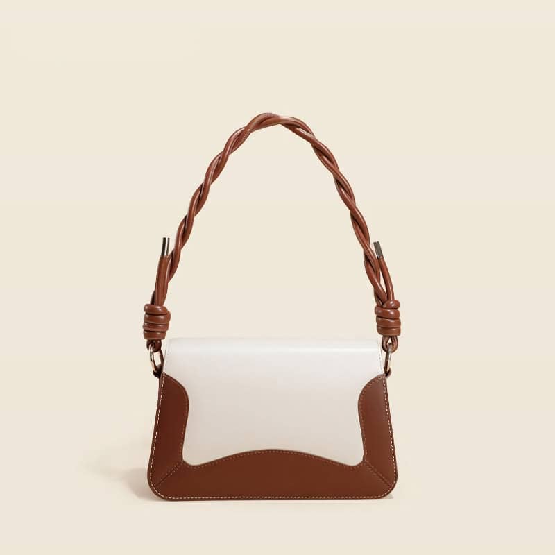Stylish leather handbag with braided shoulder strap, perfect for fashion-forward women seeking luxury accessories. Ideal for everyday use or special occasions.