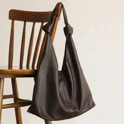 Elegant brown leather tote bag, spacious and durable, perfect for daily use, work, or travel accessories. Stylish design suitable for all occasions.