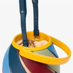 Brightly colored fashion handbag with yellow, blue, red, green, and beige leather accents, perfect for stylish accessories and eye-catching look.