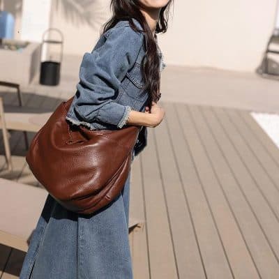 Handbag for eyewear accessories, stylish brown leather bag. Perfect for carrying glasses or sunglasses, designed for fashion-conscious customers.