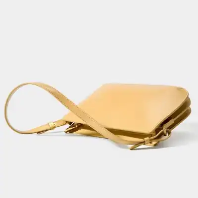 Elegant beige leather handbag with adjustable strap, perfect for everyday or special occasions, combining style and functionality for modern women.