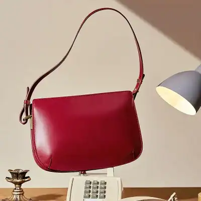 Elegant red handbag with a sleek design, perfect for daily use and special occasions. Stylish accessory that complements any outfit for women seeking luxury fashion.