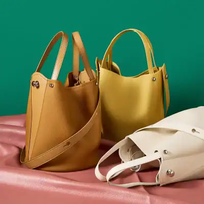 Leather handbags in yellow, brown, and white, perfect for everyday use, trendy and durable, available at Monalisa Medical store for fashionable shoppers.