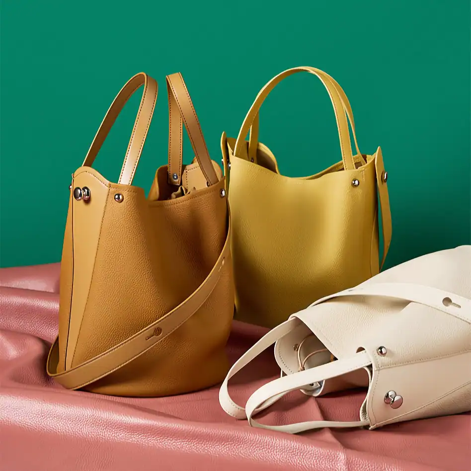 Leather handbags in yellow, brown, and white, perfect for everyday use, trendy and durable, available at Monalisa Medical store for fashionable shoppers.