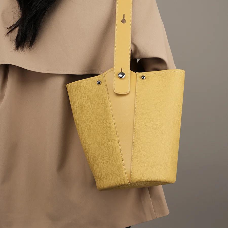 Stylish yellow leather tote bag for women, perfect for daily use and fashion. Made with high-quality material, spacious interior, and durable design. Ideal for shopping, work, or casual outings.