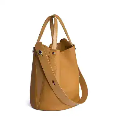 High-quality tan leather tote bag with adjustable shoulder straps, perfect for fashion-conscious individuals seeking versatile accessories.