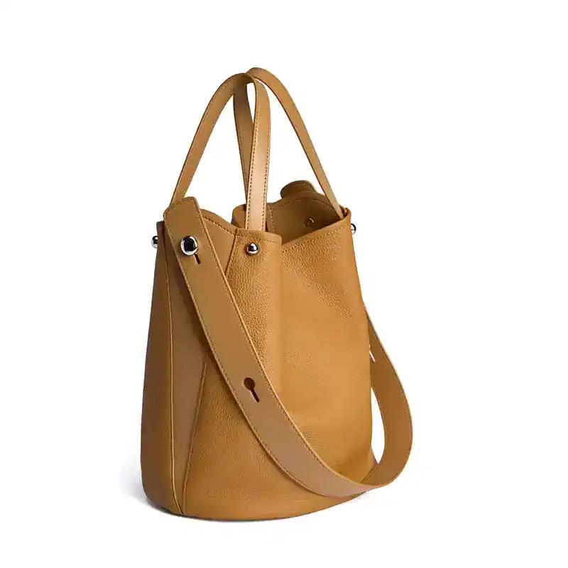 High-quality tan leather tote bag with adjustable shoulder straps, perfect for fashion-conscious individuals seeking versatile accessories.