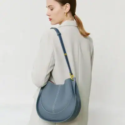 High-quality blue leather shoulder bag for women with adjustable strap and gold accents, perfect for everyday use and stylish appearances.